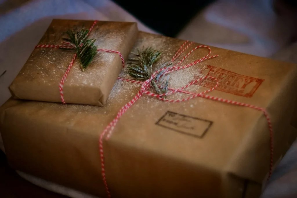 Brown paper gifts tied with twine and decorated with evergreen sprigs